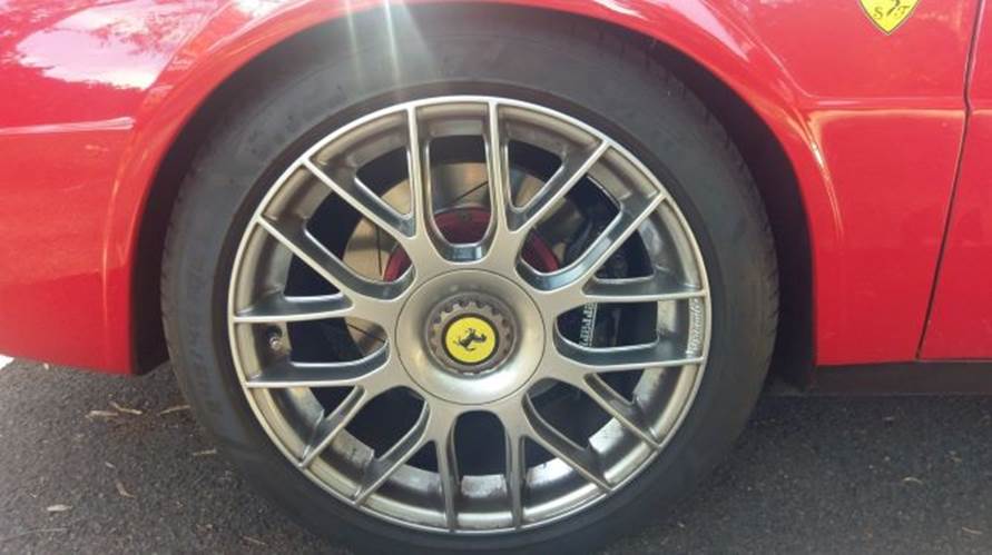 A red car with a black rim

Description automatically generated with low confidence