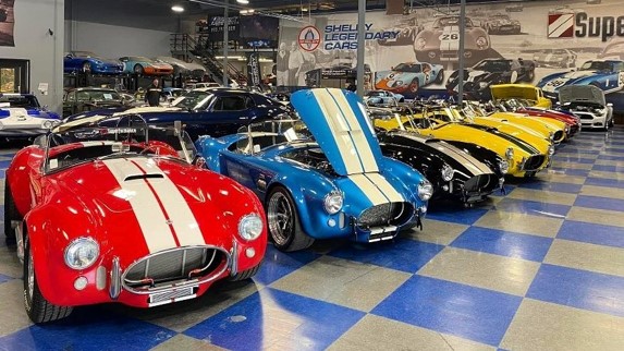 A group of cars parked in a showroom  Description automatically generated with medium confidence